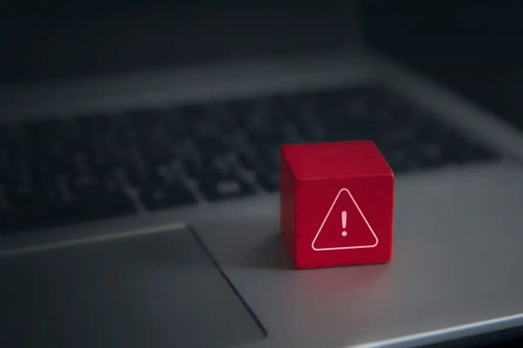 Developers urged to immediately upgrade React, Next.js Red-warning-cube-on-a-laptop-keyboard-in-darkened-room-1
