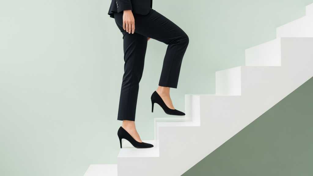 What it takes to step into a C-level technology role digital illustration of a corporate woman ascending stairs