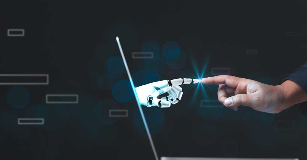 Why AI agents are so good at coding A human finger touches an android finger through a laptop interface.