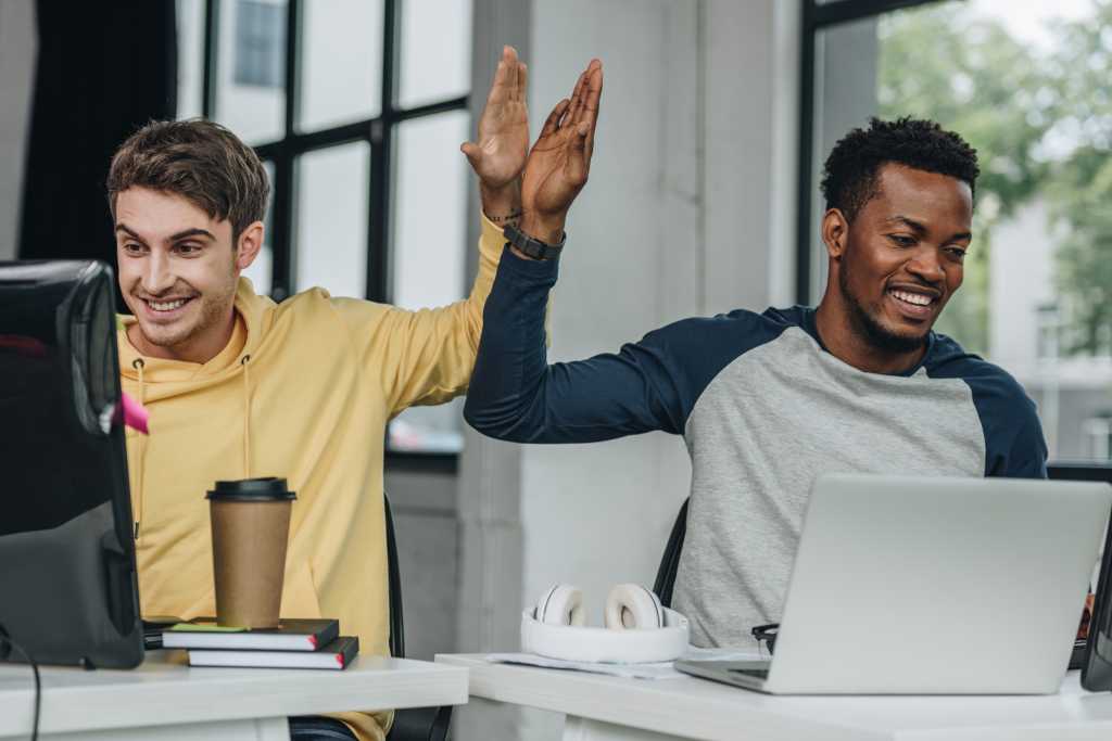 A first look at XAML Studio 2.0 happy multicultural programmers developers giving high five while working in office together
