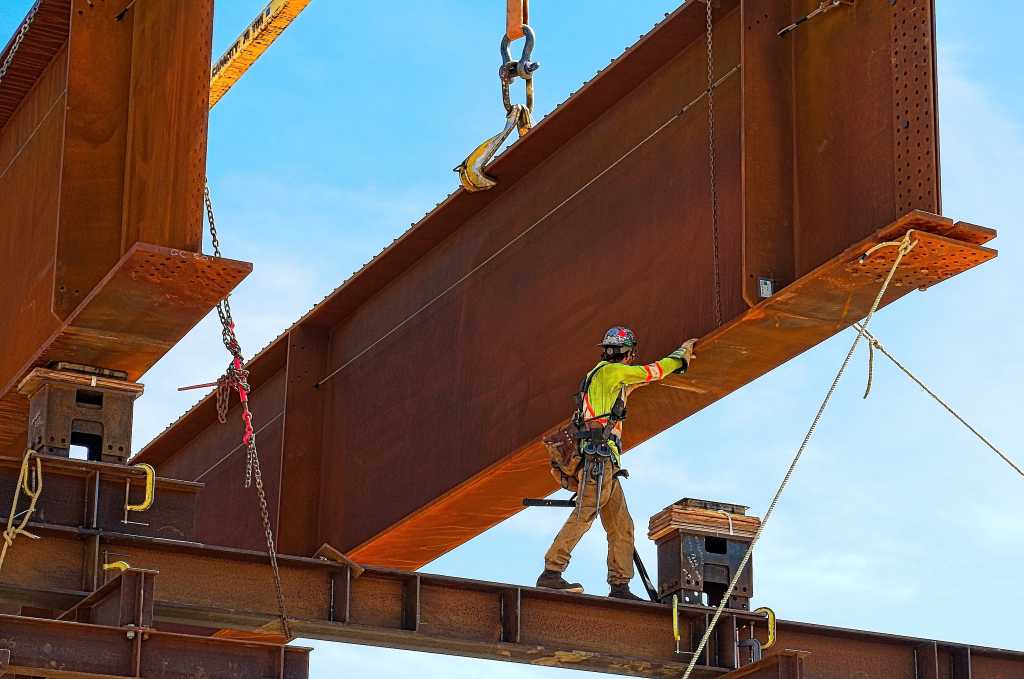 AI-built Rue language pairs Rust memory safety with ease of use Rusty steel girder and two meter web installed on a bridge abutment and scaffolding as part of a new freeway interchange. Building construction infrastructure project.