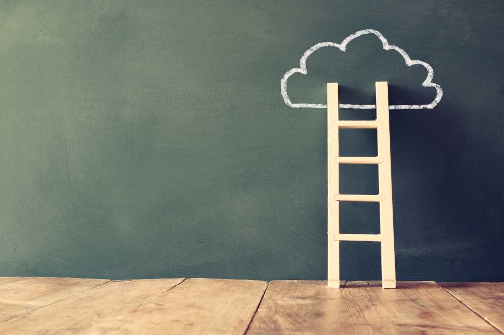The best free cloud computing courses in 2026 Short wooden ladder on a wooden floor leaning against a cloud drawn in white chalk on a blackboard wall.