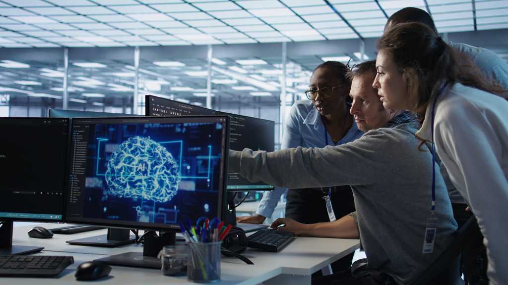 The forward-deployed engineer: Why talent, not technology, is the true bottleneck for enterprise AI Engineer calling colleagues after finding error in code while doing checkup on server room used for AI workloads. Man requesting help from coworkers after finding bug in data center systems, camera B