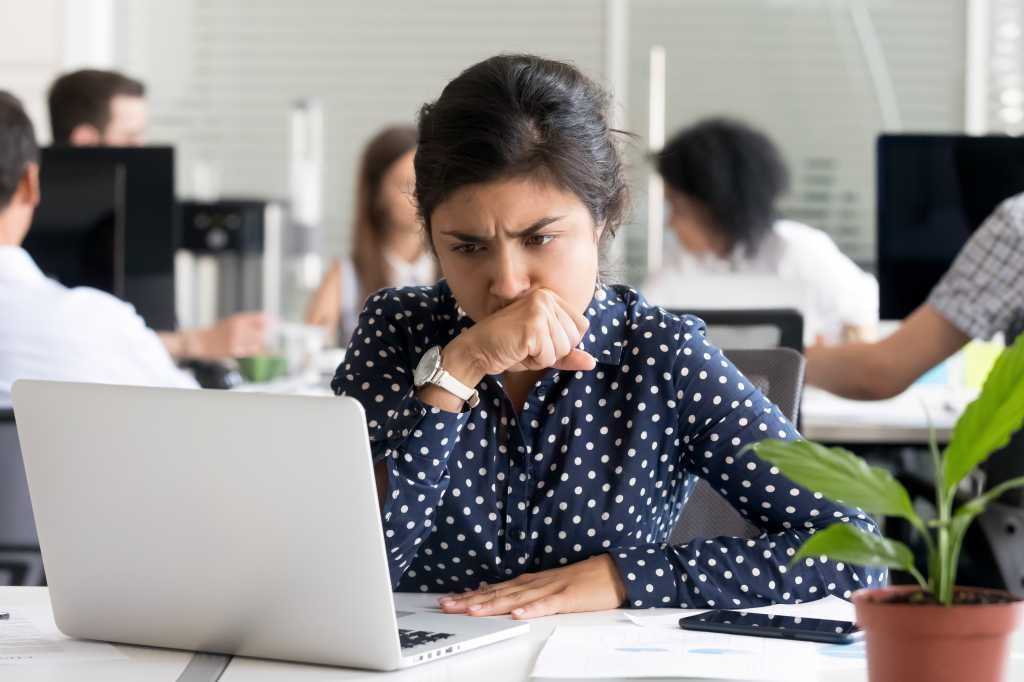 Developers on H-1B face a tighter job market as AI shifts hiring priorities Focused worried Indian businesswoman looking at laptop screen, doubting, thinking of difficult question or task, female employee upset by receiving bad news, tired office worker have too much work