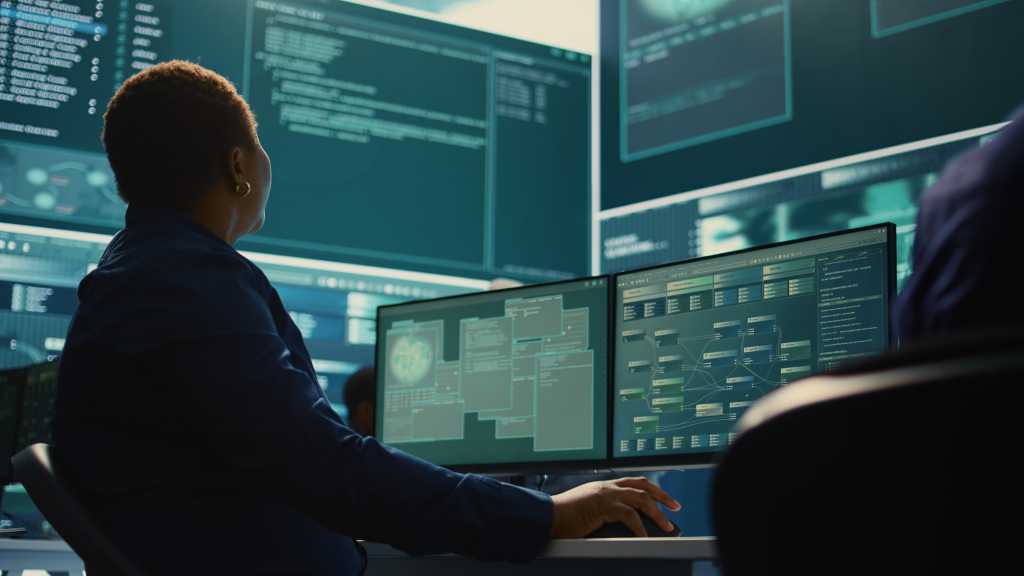 Databricks targets AI operations bottlenecks with ZeroOps Cyber security expert working on encryption and IT security in a governmental agency. Woman engaging on cyber operations, network security and data protection for hybrid war. Camera B.