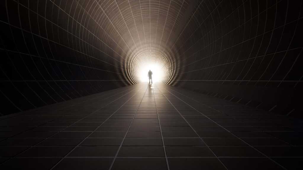 Why AI coding debt is different shutterstock 1901776579 figure walking toward bright light at the end of a dark tunnel