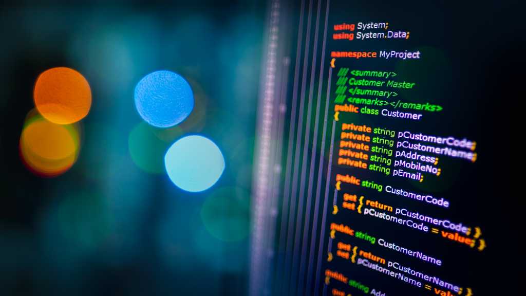 Best practices for using AI to generate C# code C# programming language C sharp source code example on monitor and bokeh background.