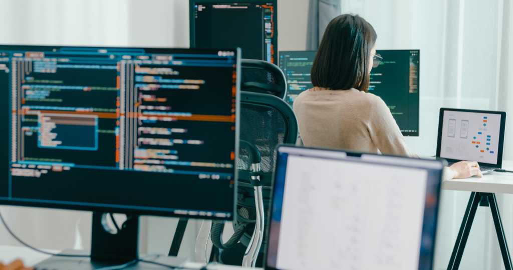 CrowdStrike identifies five new AI prompt injection threats Group Adult Asia male, female freelance typing write prompt AI bot IT app smart program nomad, video game, terminal with coding language, user interface, designer, big data center on desktop computer.